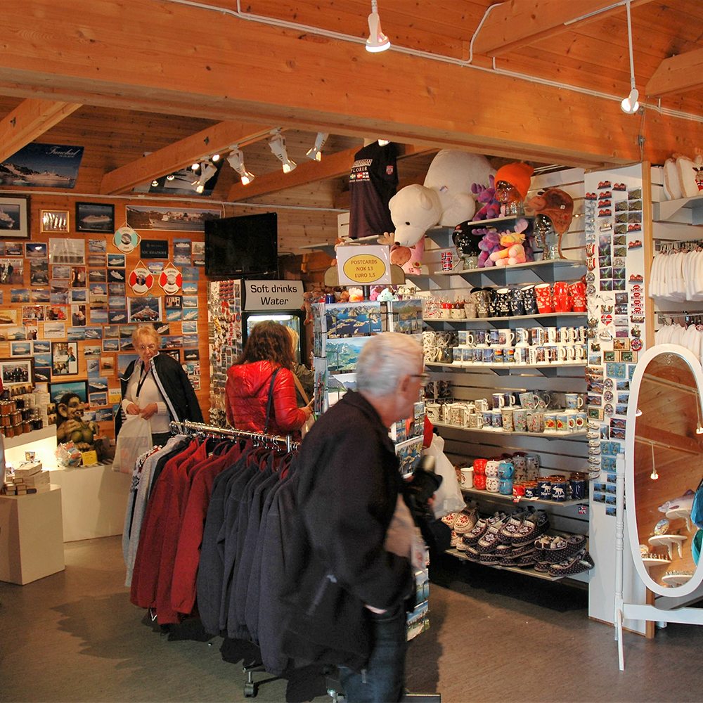 Interior of a store with clothing racks and shelves displaying various items.