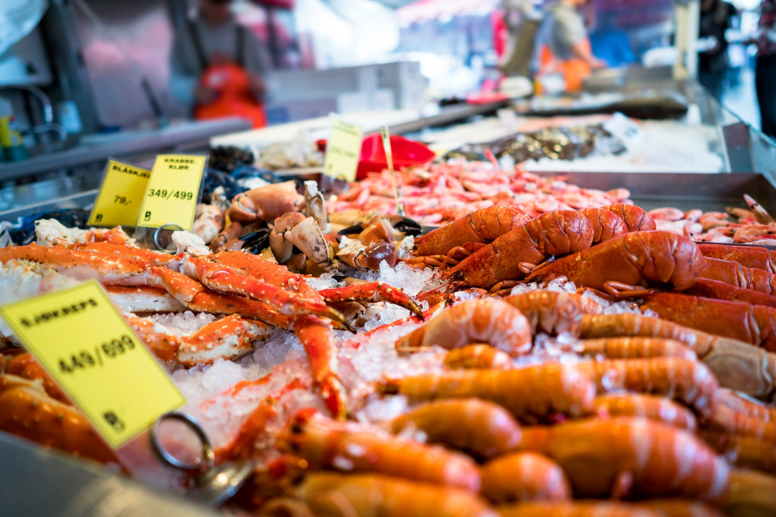 Seafood display with crabs and shrimp on ice at a market.
