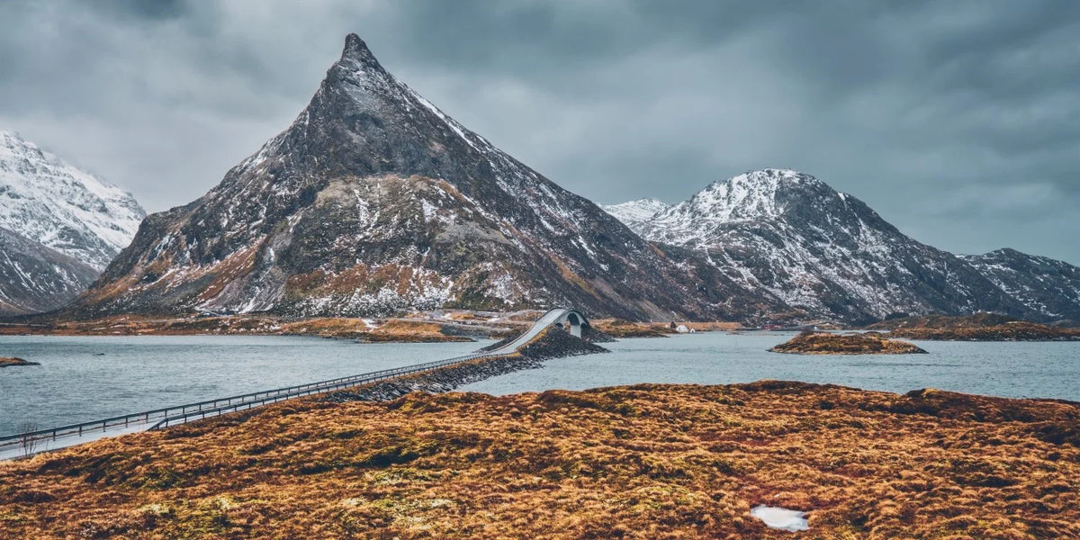 Mountain landscape with a road leading to a snow-capped peak
